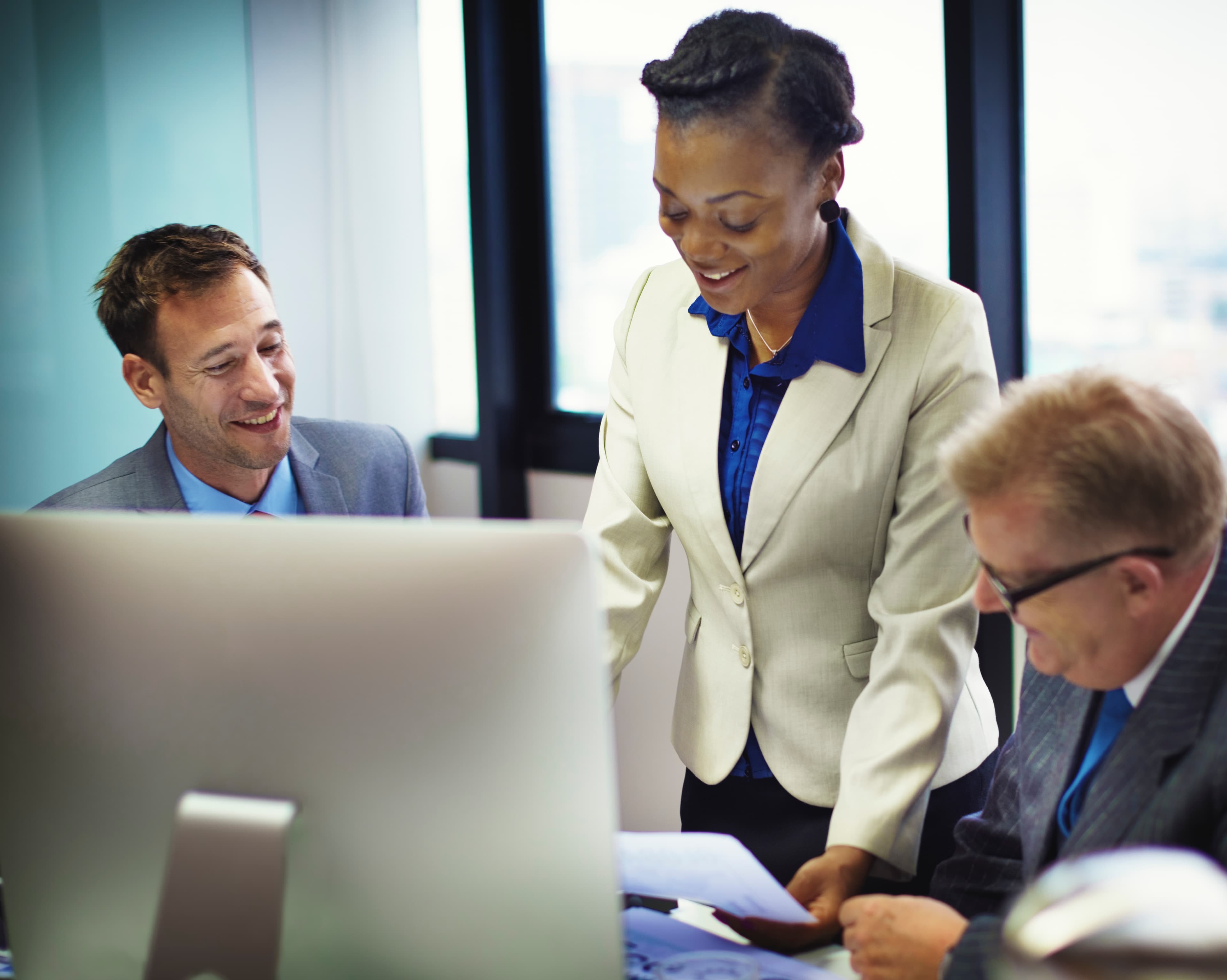 Business professionals reviewing documents together at an office desk
